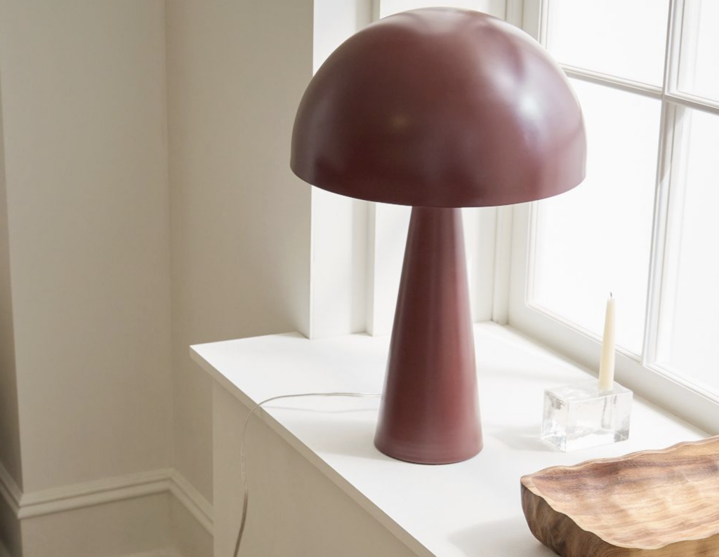 Hastings Table Lamp by West Elm in Oxblood by a window